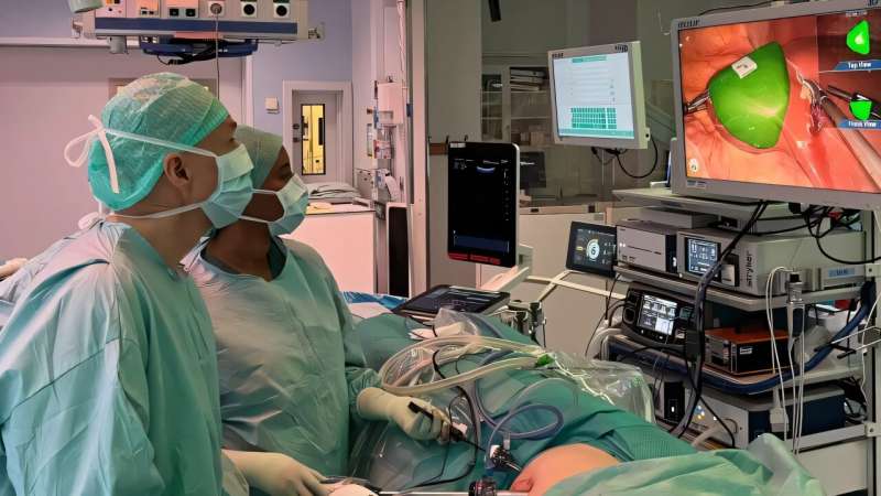 The new technology uses augmented reality to overlay a 3D visualization of the tumor and other anatomical structures on the surgeon's camera view. Here, Niclas Kvarnström, transplant surgeon and head of the Transplant Centre, and Fatuma Shieriye, specialist physician, perform the first operation using the new technology. Credit: Jenny Cedås. Interactive 3D technology reveals hidden tumours during surgery