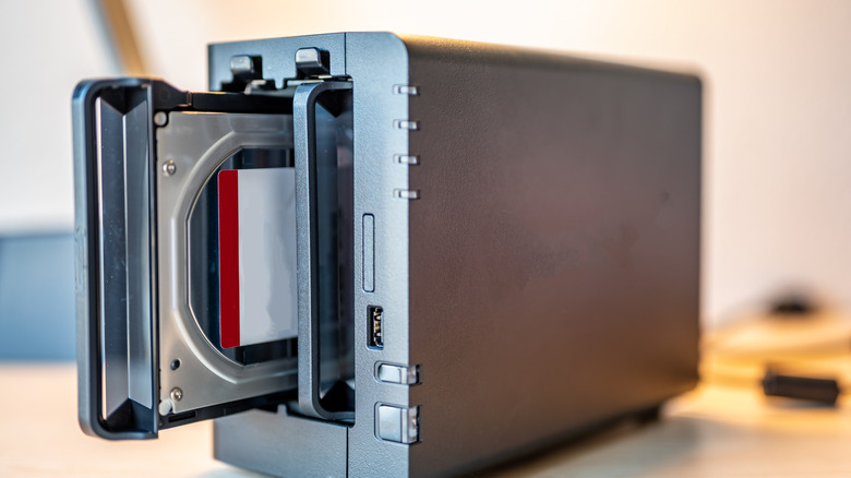 A RAID enclosure with an HDD being installed in it.