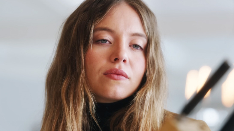 Sydney Sweeney's Millie Calloway looks down in closeup in The Housemaid