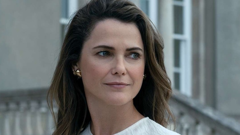Kate looking to the side and smiling in The Diplomat