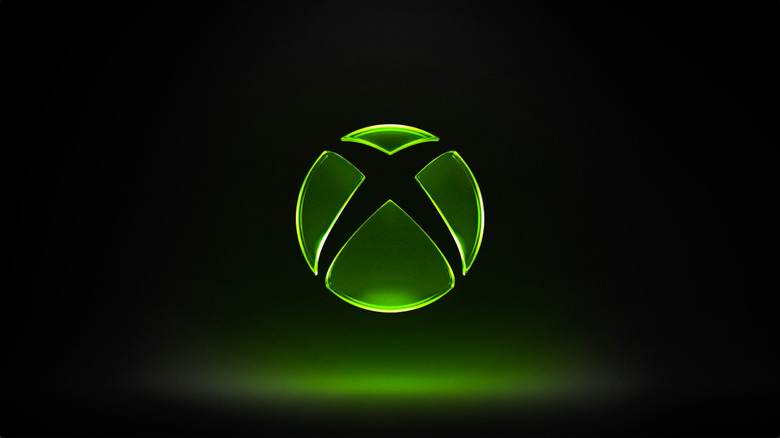 Illustration of a green glowing Xbox logo displayed on a black backdrop.