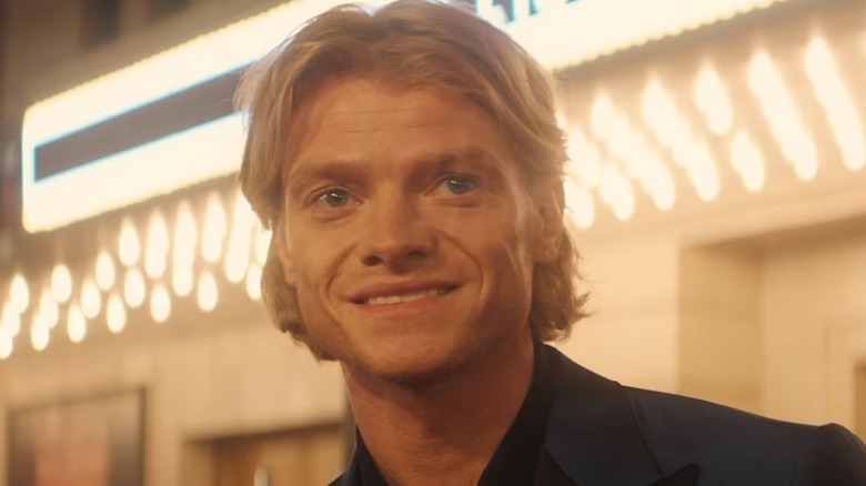 Matt Hagen smiling in front of a theater in Clayface