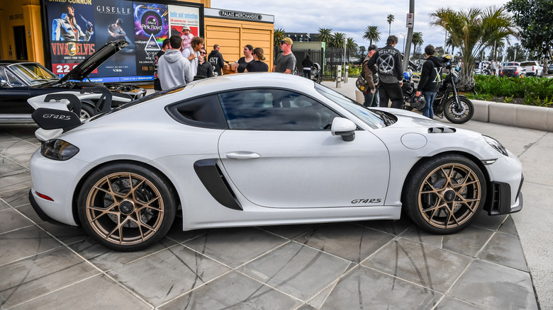 A white Porsche 718 Cayman GT4 RS with center lock wheels