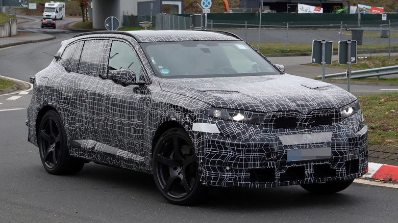 A camouflaged prototype of the next BMW X5 M during testing in Germany.