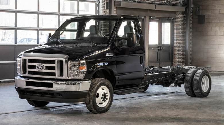 A black Ford E-350 chassis