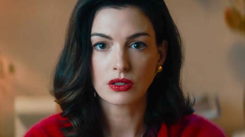 Verity in close-up wearing red with red lipstick in Verity