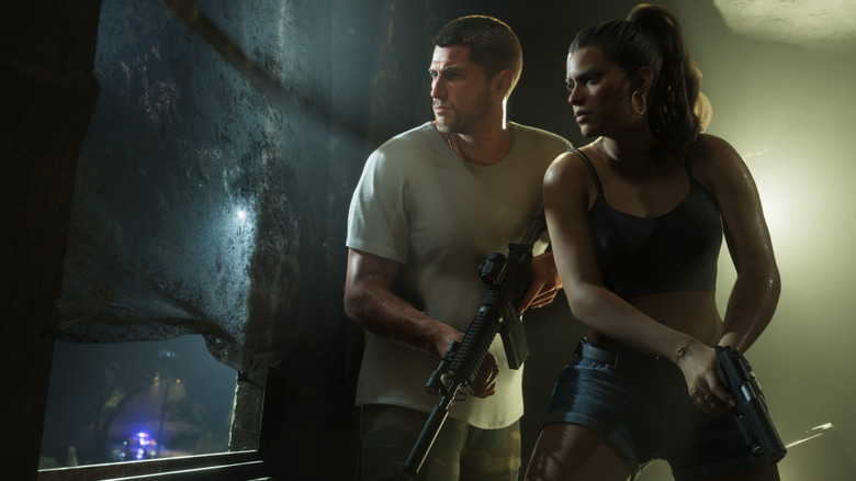Screenshot from Grand Theft Auto 6. Characters Jason and Lucia hold guns at the ready, both staring to the left out a dirty window.