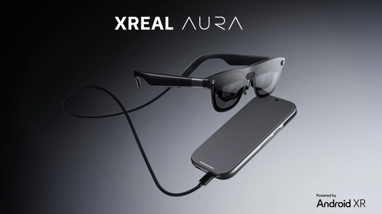 Xreal Aura smartglasses on black background.