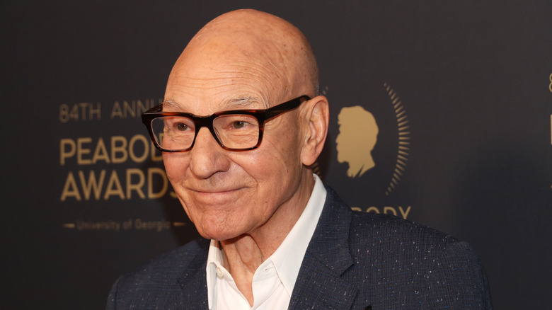 Patrick Stewart on the red carpet, smiling