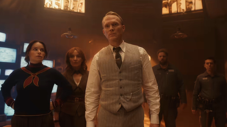 Paul Bettany as Vision standing in a room next to Emily Hampshire as Edith, Orla Brady as Friday, Jonathan Sayer as U, and Henry Lewis as DUM-E in VisionQuest
