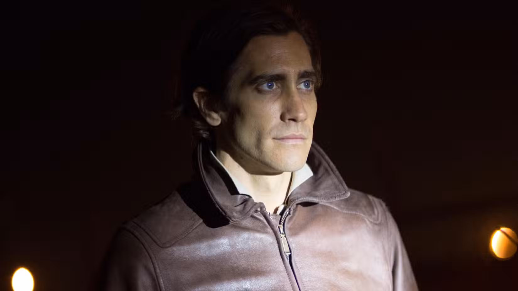 Jake Gyllenhaal with a flashlight shining on him in Nightcrawler