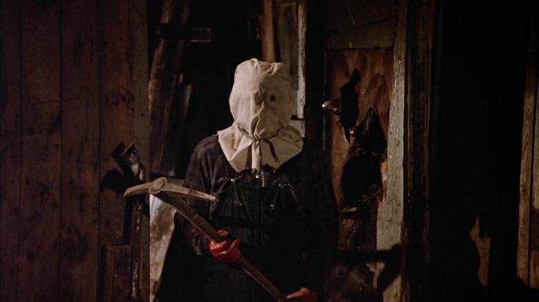 Jason Voorhees in his shack with a pickaxe in Friday the 13th Part 2