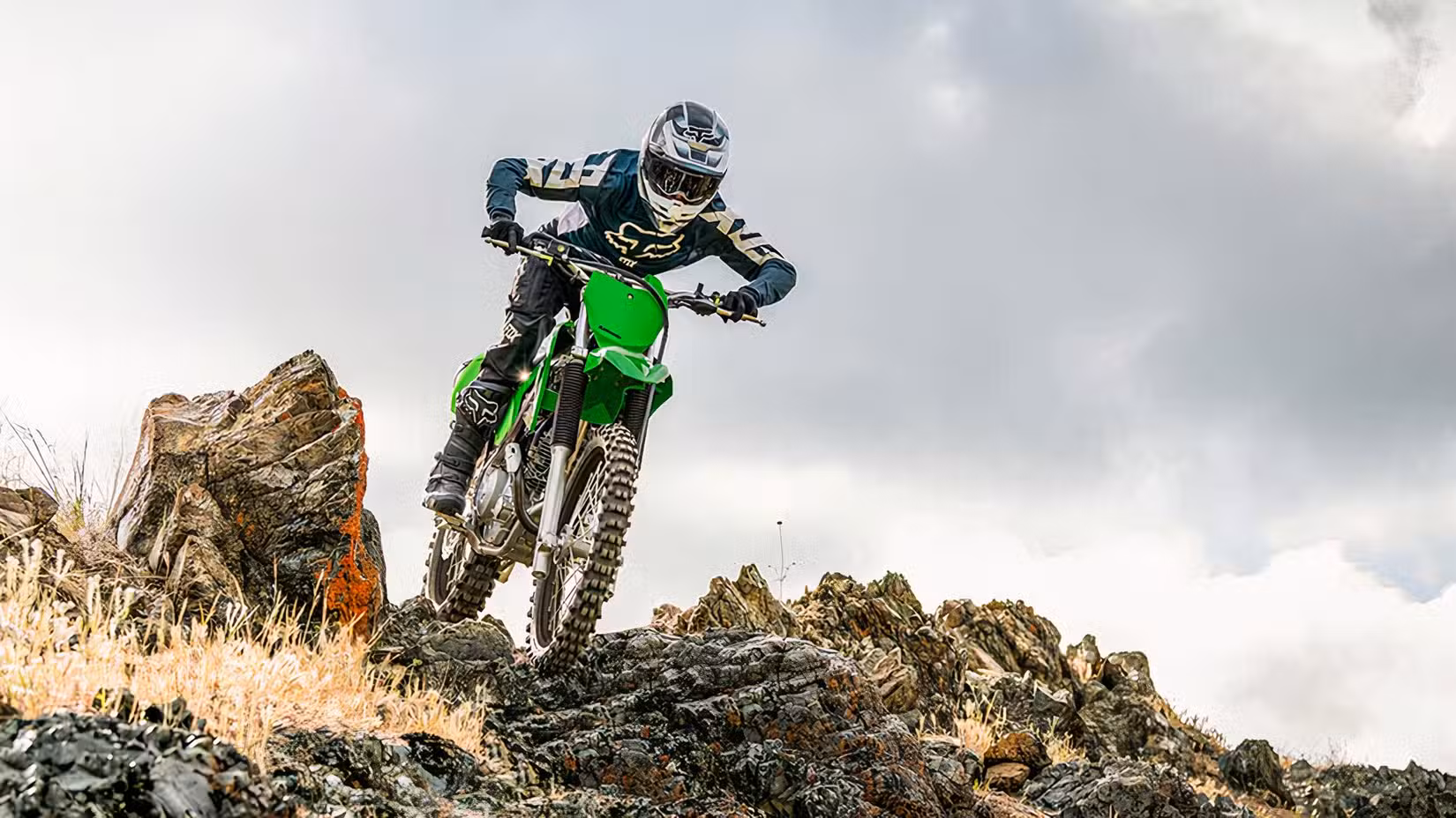 Action shot of Kawasaki KLX230R beginning a hill descent off-road