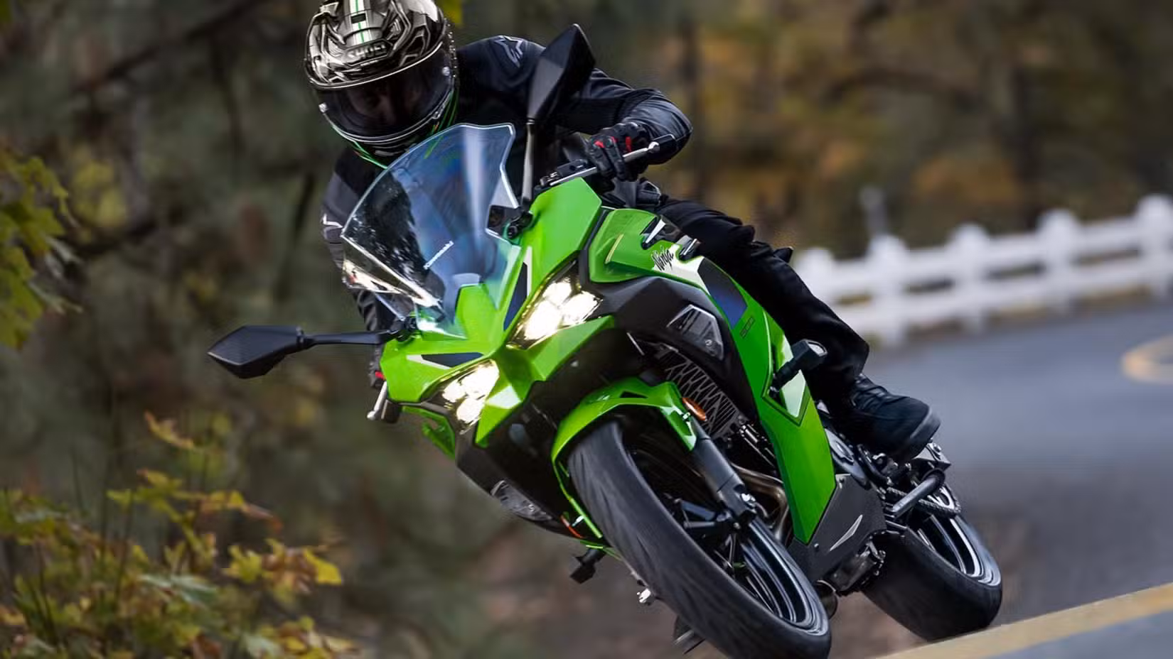 Action shot of a green 2026 Kawasaki Ninja 500 riding on a canyon road