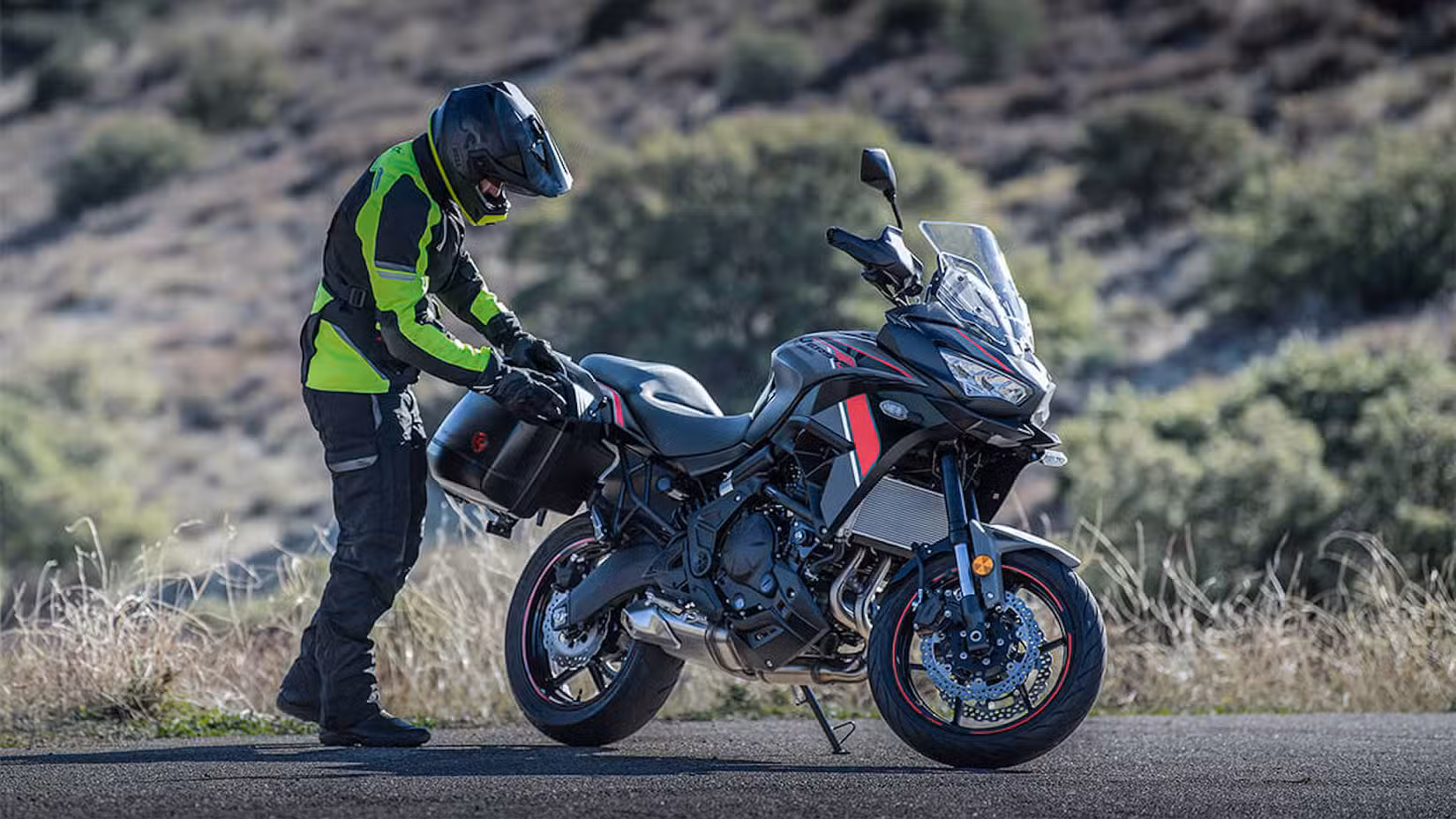 Rider packing luggage on a Kawasaki Versys 650 LT