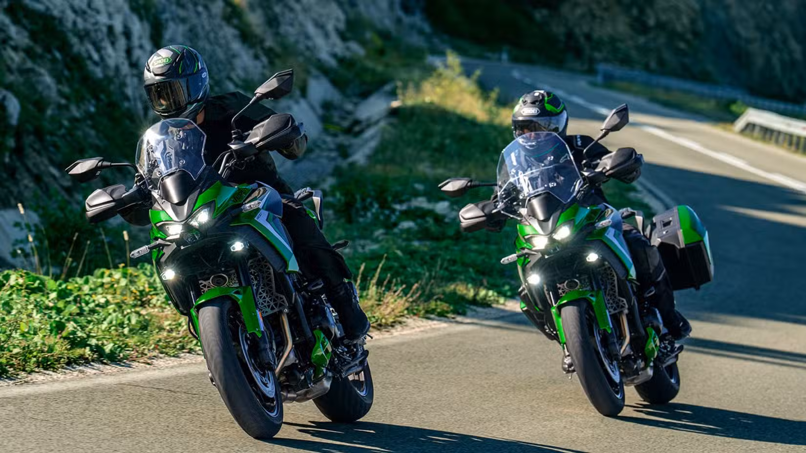 Action shot of two Kawasaki Versys 900 SE LT on a winding road