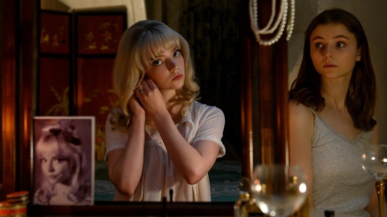 Sandie looking at herself in a mirror while Ellie watches in Last Night in Soho