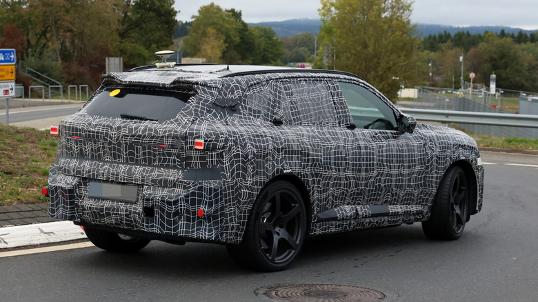 The rear end of the camouflaged BMW X5 M prototype with provisional taillights