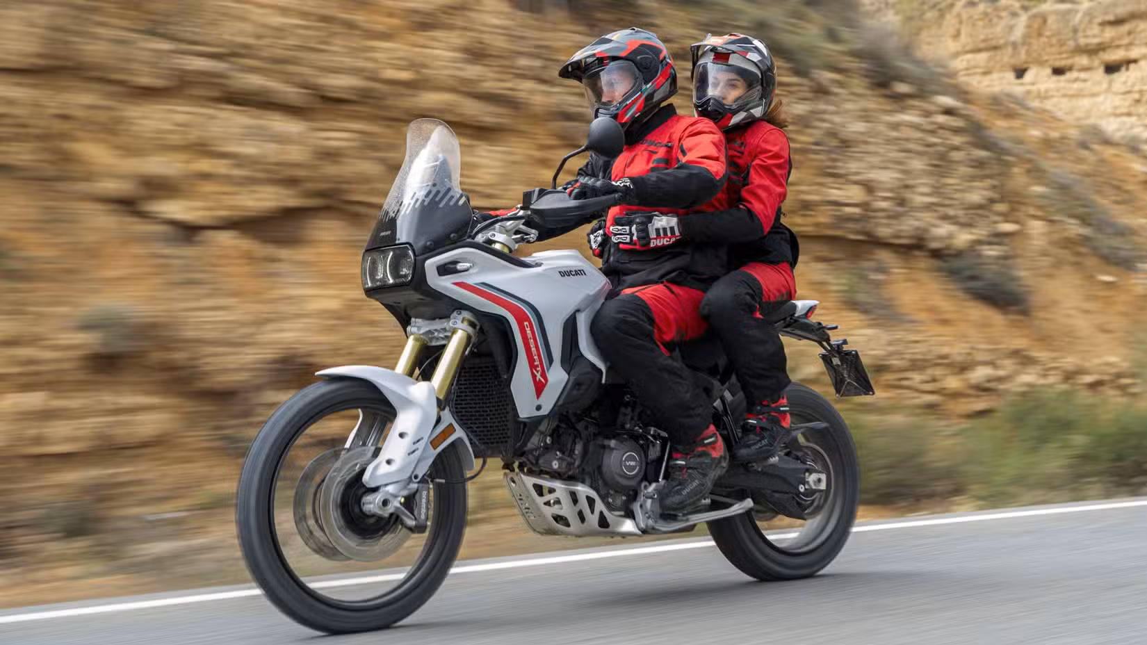 2026 Ducati DesertX V2 touring comfortably on the road with rider and pillion