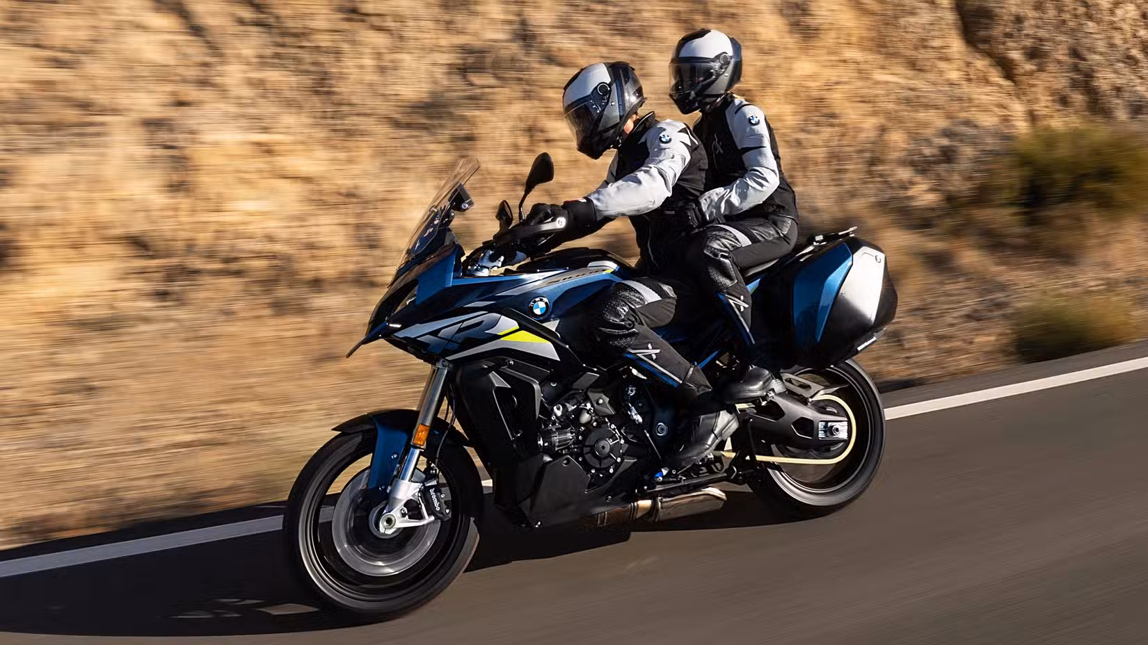 BMW S 1000 XR accelerating with the rider and pillion