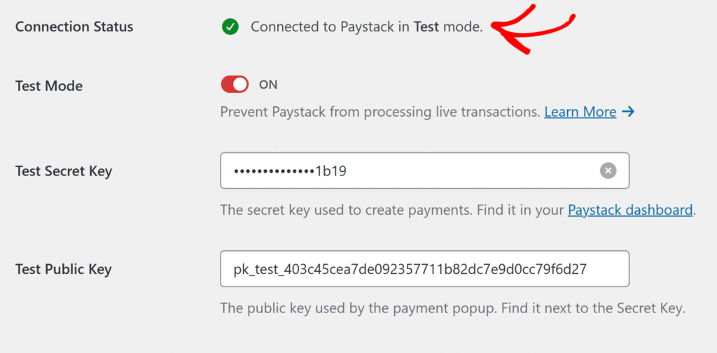 Paystack settings screen: connection is live in Test mode, with a green check mark indicating connected status, and fields for Test Secret Key and Test Public Key with explanatory text beneath each field.