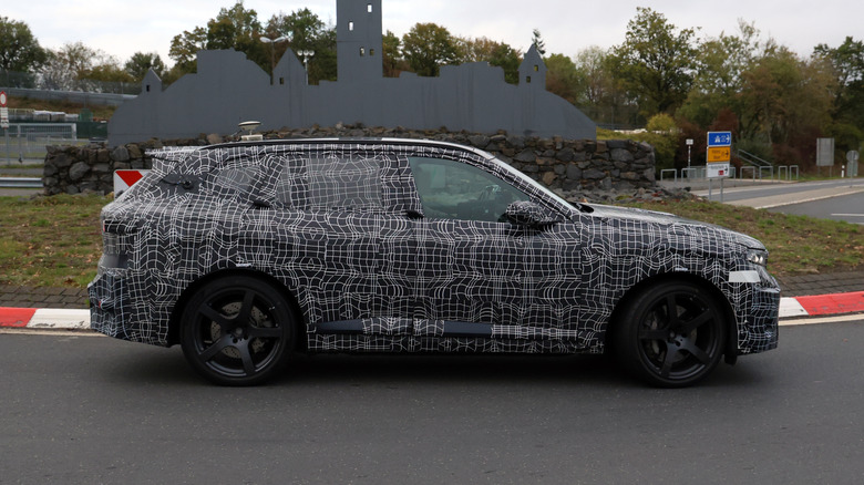 A profile view of the camouflaged BMW X5 prototype at the Nürburgring.