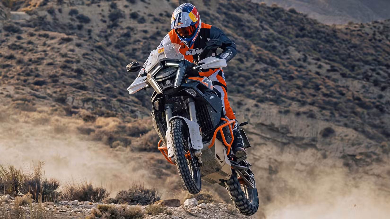 2026 KTM 1390 Super Adventure R taking flight on an off-road run front third quarter view