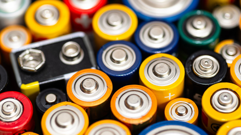 A stack of various alkaline batteries. including AAA, AA and a single 9-volt.