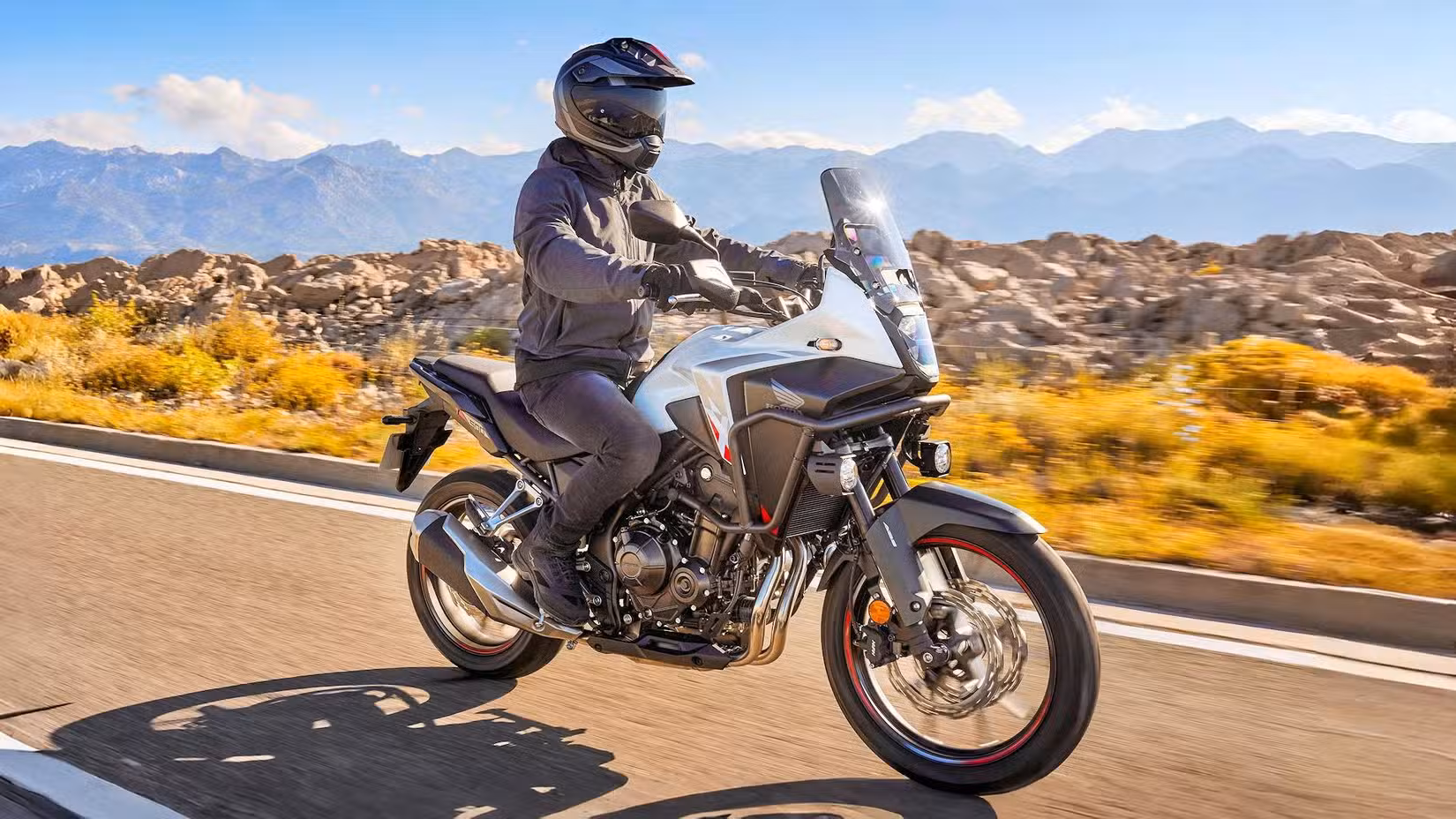 Rider on a Honda NX500 cruising down the highway