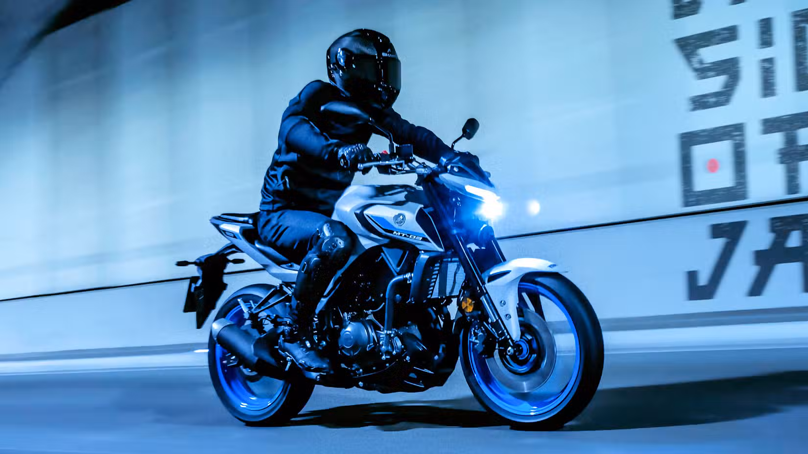 Front quarter shot of 2025 Yamaha MT-03 being ridden in an urban environment