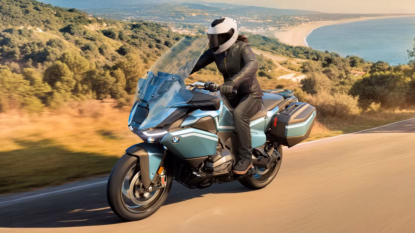Rider on a 2026 BMW R 1300 RT cruising on a mountain road