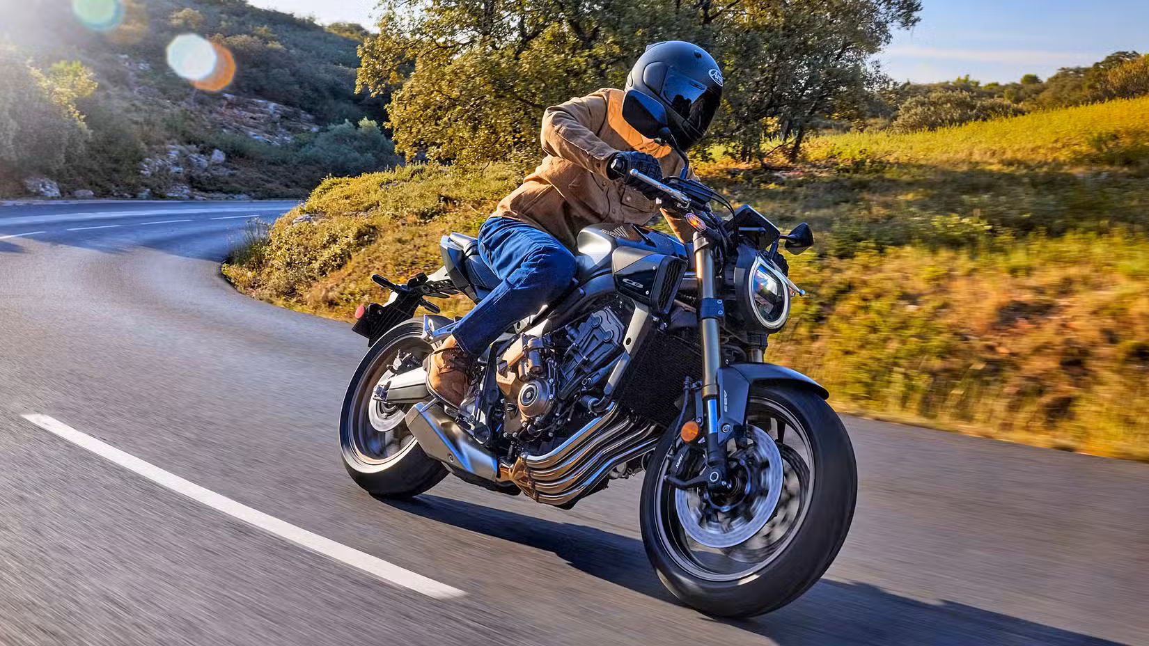 Rider on a 2026 Honda CB650R E-Clutch coming out of a corner
