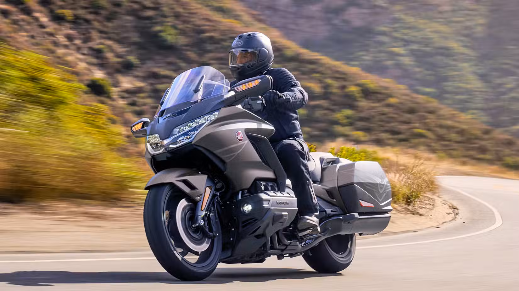 Rider on a 2026 Honda Gold Wing cruising along winding road