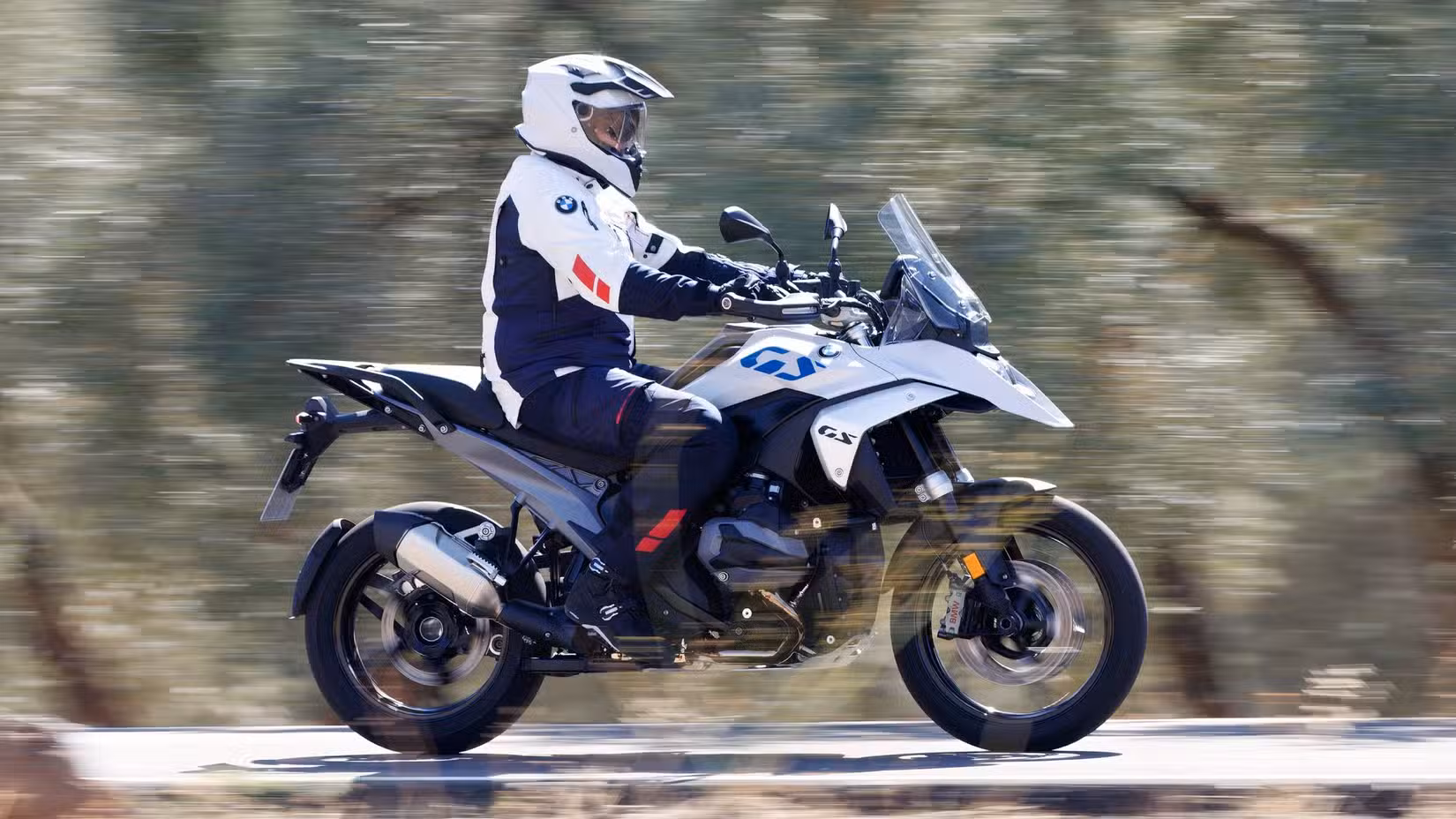 Side profile view of a rider riding aboard the BMW R 1300 GS