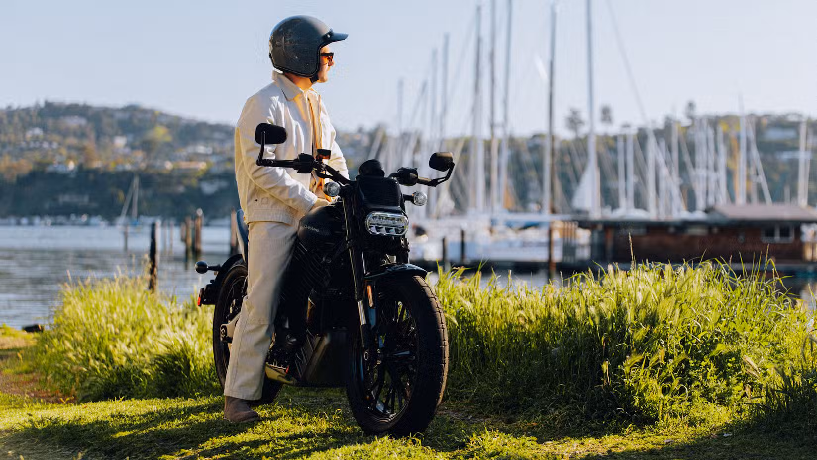 Rider sitting on a LiveWire S2 Del Mar overlooking the harbor