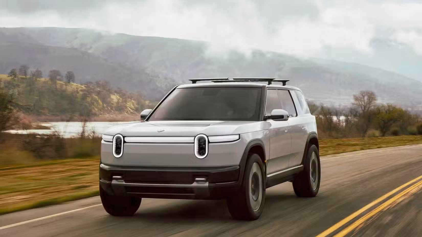 Front three-quarters action shot of a silver Rivian R2