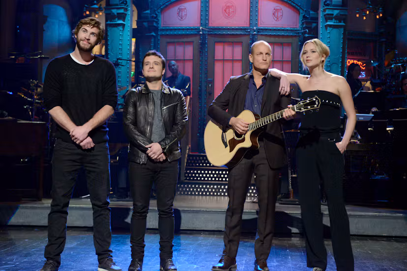 Liam Hemsworth, Josh Hutcherson, Woody Harrelson and Jennifer Lawrence sing during the monologue on ...