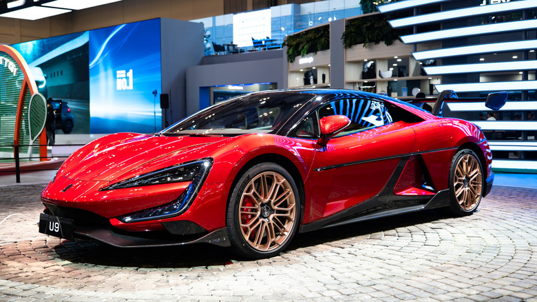 A red Yangwang U9 at a motorshow