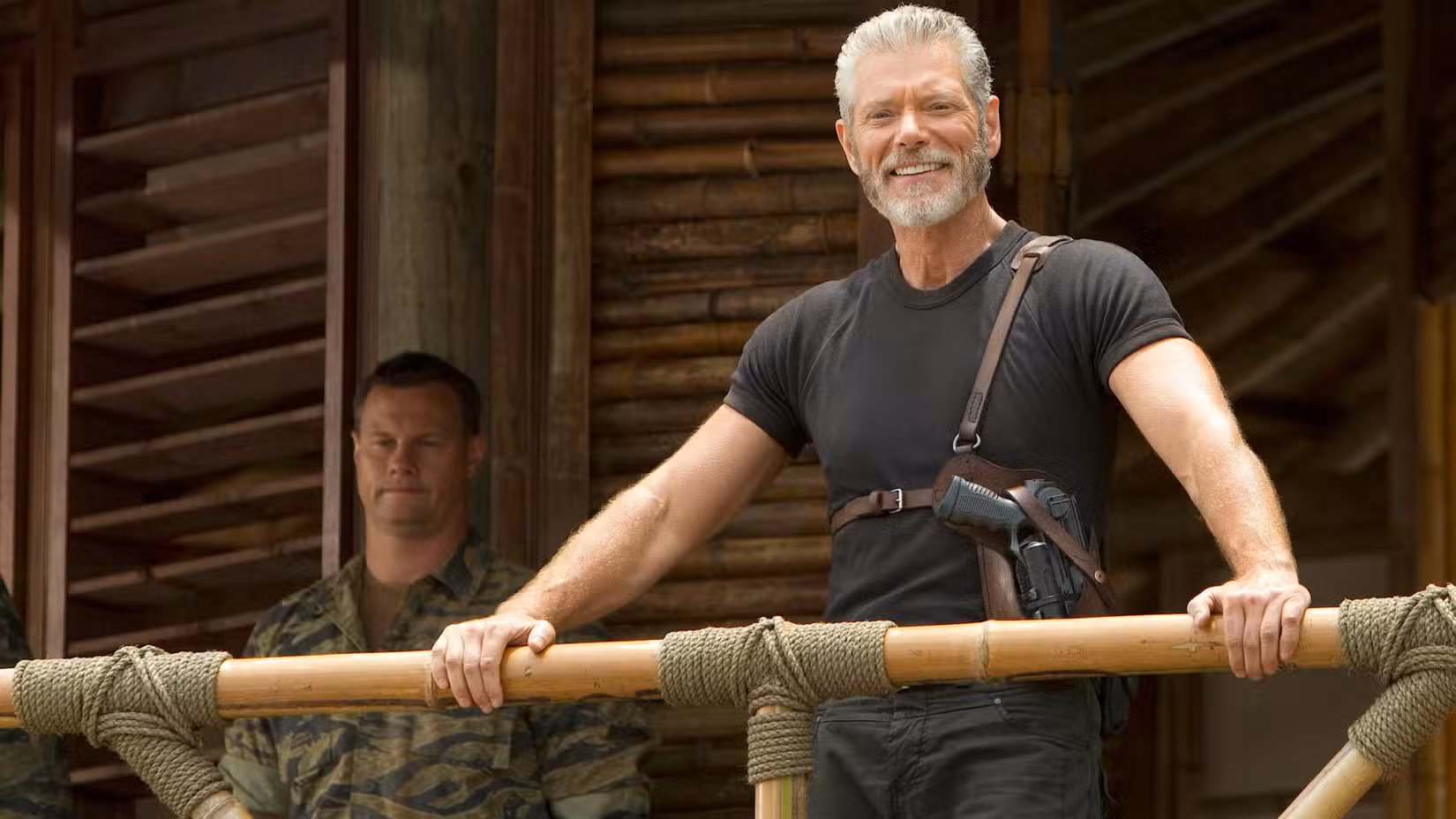 Stephen Lang as Commander Nathaniel Taylor smiling and leaning over a railing in Terra Nova