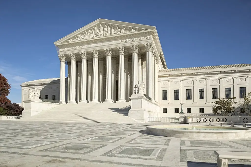 The white marble exterior facade of the Supreme Court of the United States building in Washington, D.C.
