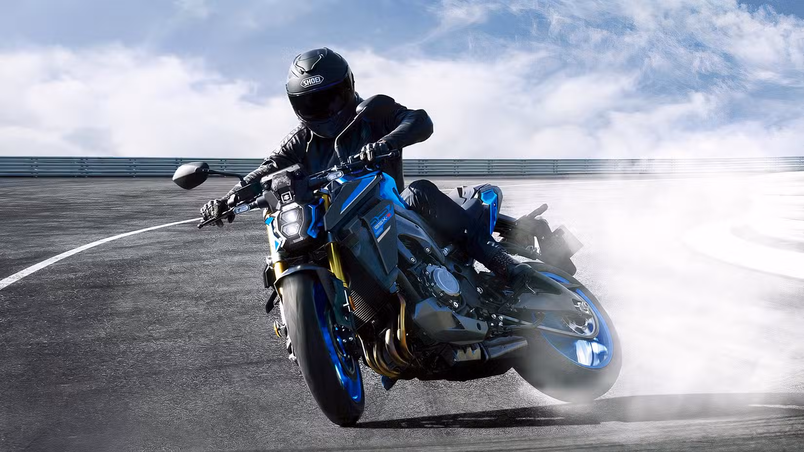 Rider sliding a Suzuki GSX-S1000 sideways