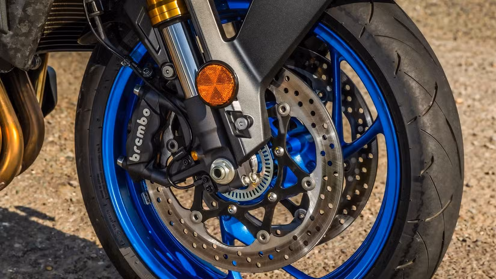 Close up shot of a Suzuki GSX-S1000's front tire and brakes