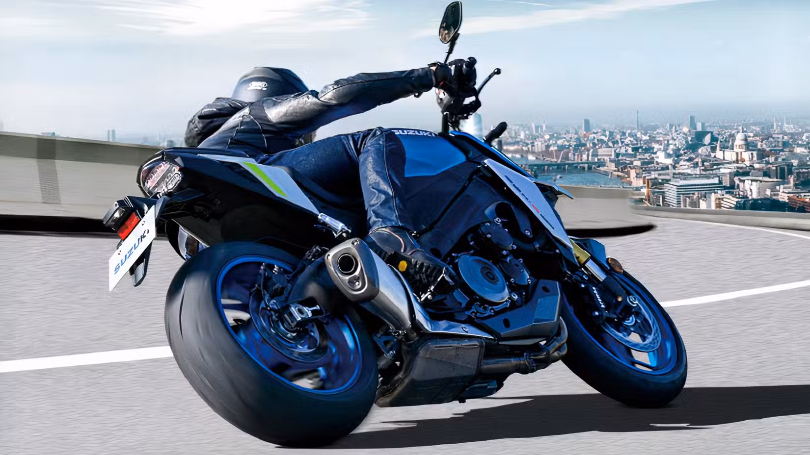 Rear quarter shot of a Suzuki GSX-S1000 cornering hard to the left