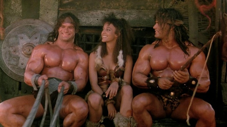 Kutchek, Ismene, and Gore driving a large carriage in The Barbarians