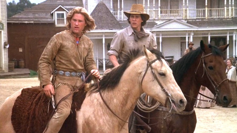 Kurt Russell's Morgan Beaudine and Tim Matheson's Quinton Beaudine looks off to their right as they sit on horses in The Quest