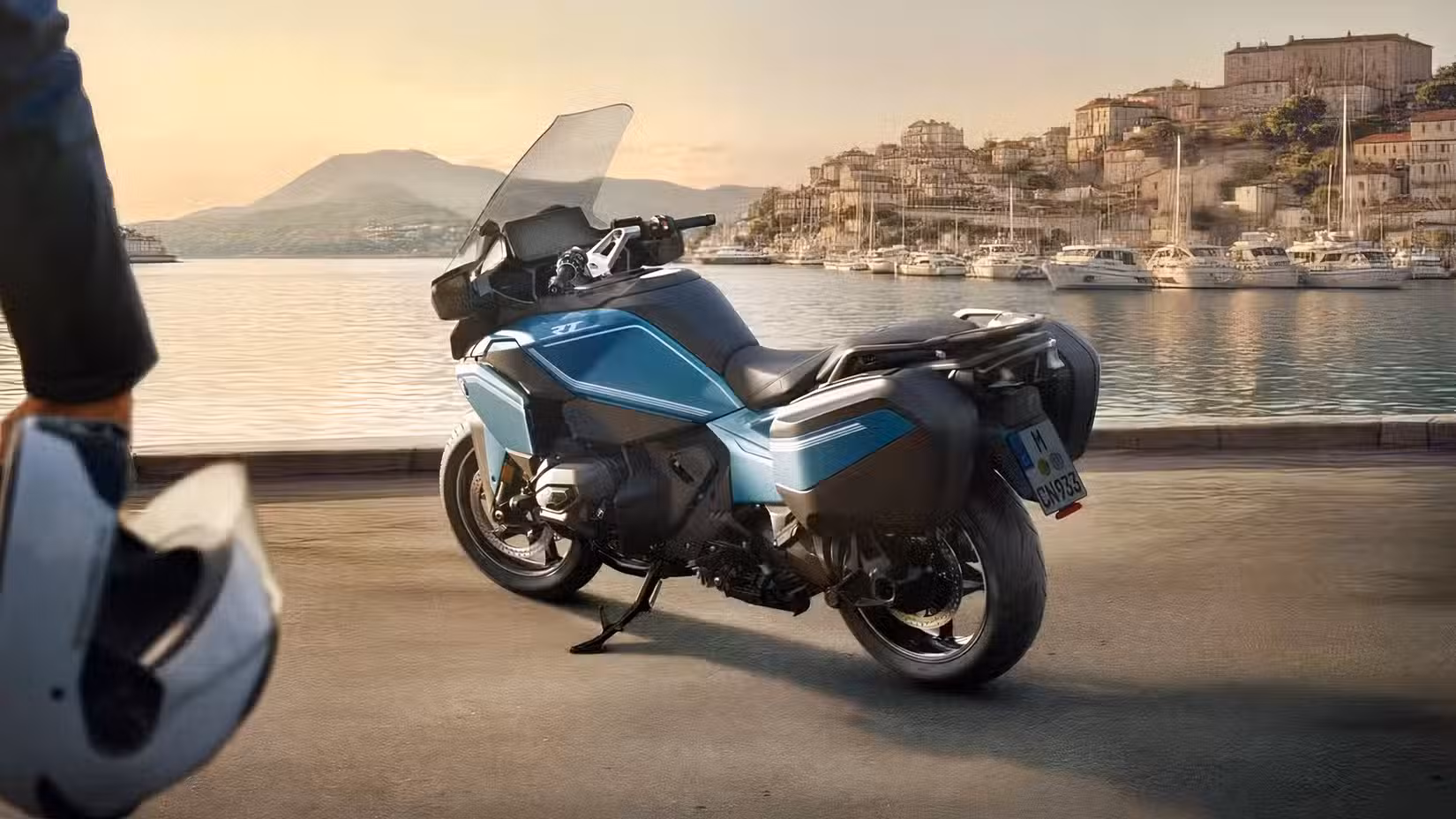 2026 BMW R 1300 RT rear three quarter view of it parked near the ocean with yachts in a harbor in the background