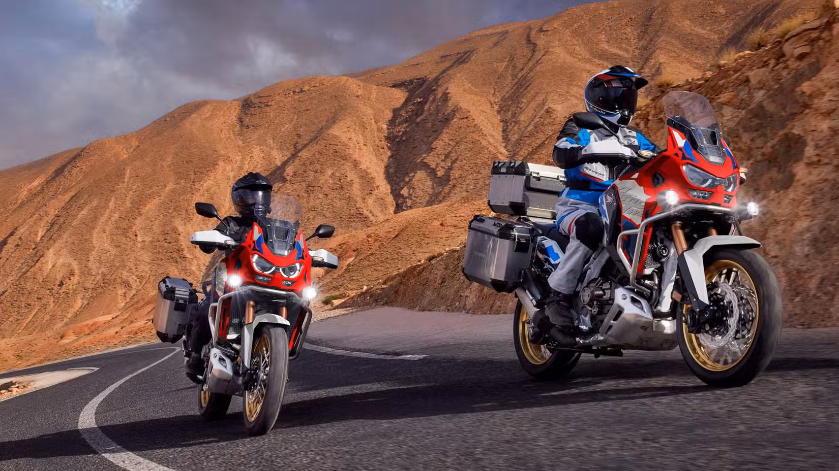 Two 2026 Honda Africa Twin Adventure Sports riding in the canyons