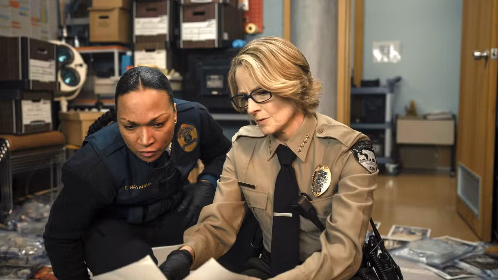 Two characters from True Detective season 4 looking at the notes