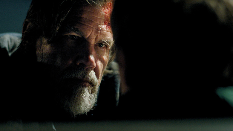 Josh Brolin as Mitt Gardiner with his forehead covered in blood and glaring at Austin Abrams as Jay Gardiner in Whalefall