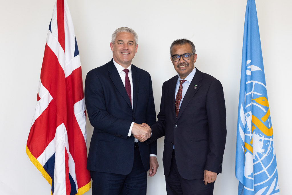 WHO Director-General Dr Tedros Adhanom Ghebreyesus and UK Secretary of State for Health and Social Care Steve Barclay MP shake hands